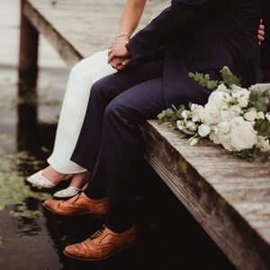 Couple Sitting on Lake Boardwalk